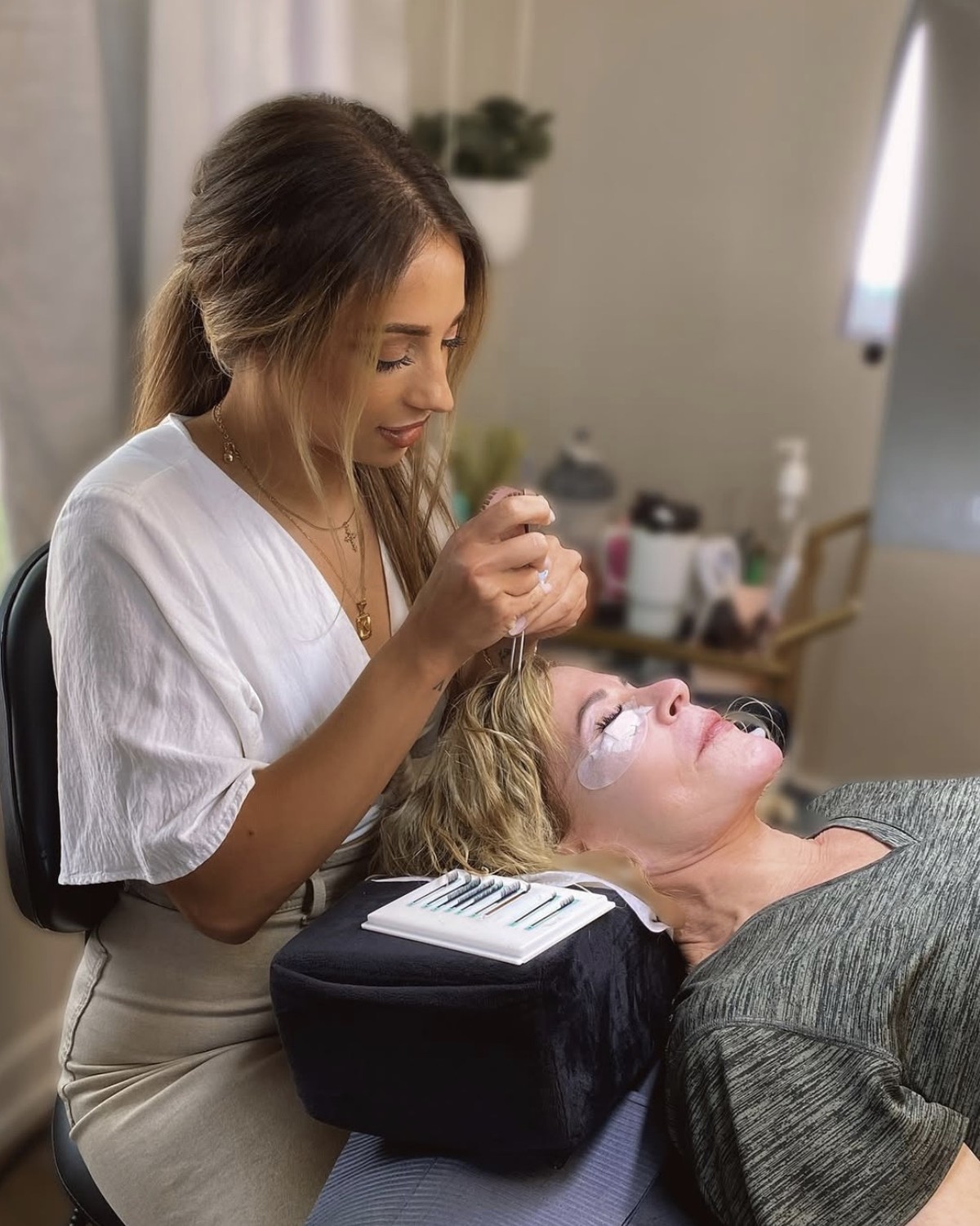 Mandie applying lash extensions to a client in the Haven Lash Co. studio